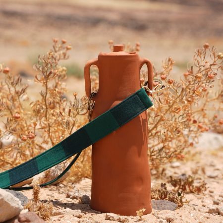 Clay water bottle in desert of Jordan