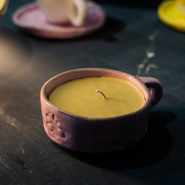 pink handcrafted candles come in cappuccino cups.