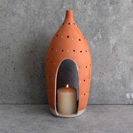 Handcrafted HANDCRAFTED CURVED LANTERNS made from terracotta with organic curves, ideal for creating a soft, peaceful glow indoors or outdoors.
